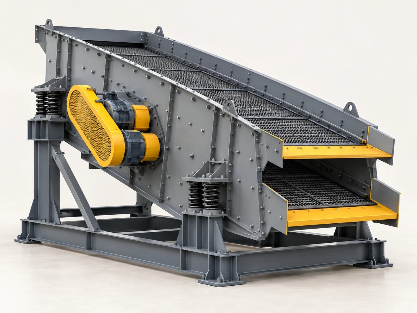 A vibrating screen separates material into size fractions as it moves across screened decks.