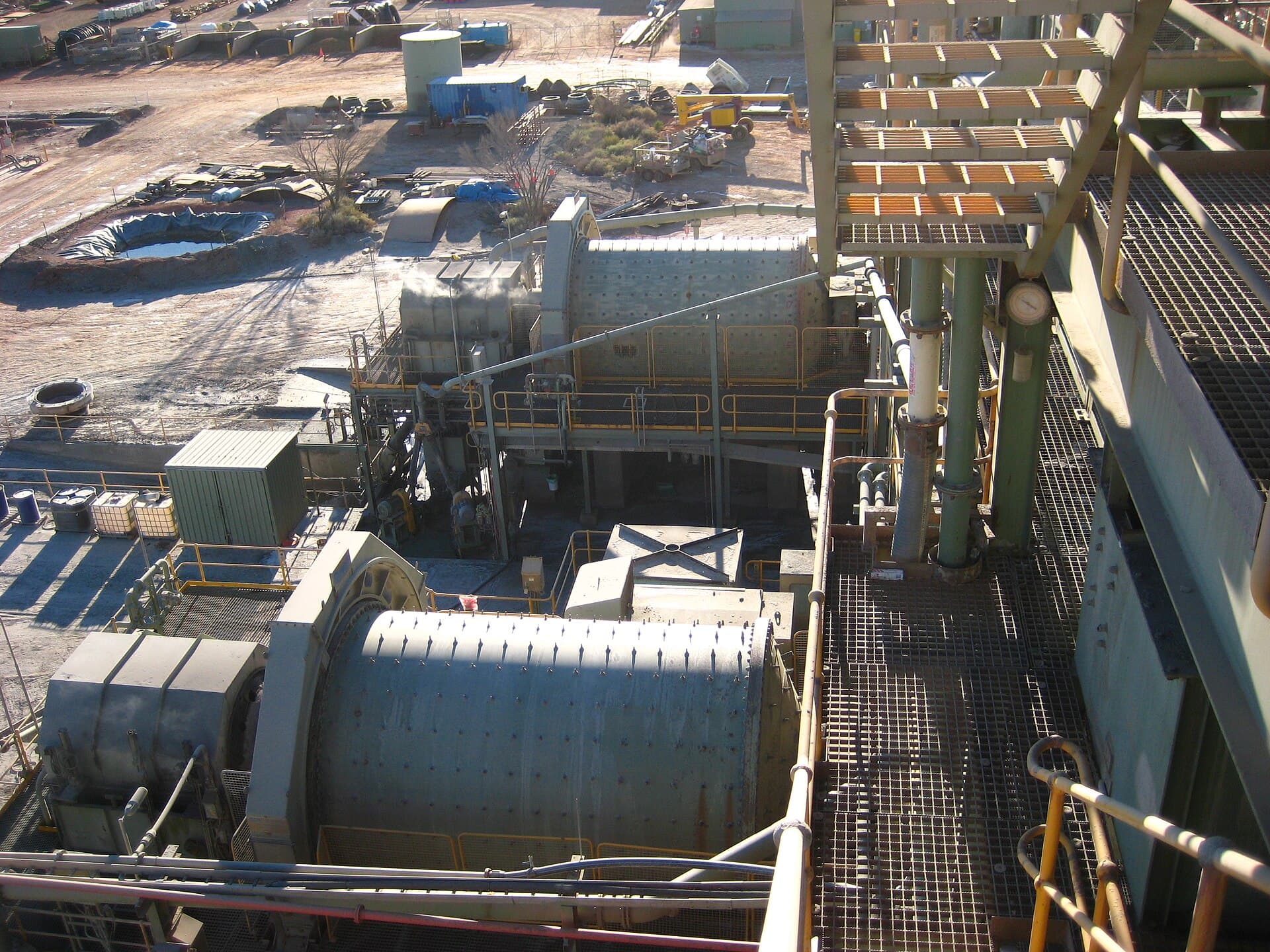Wet pan mill grinding gold ore in a circular steel pan
